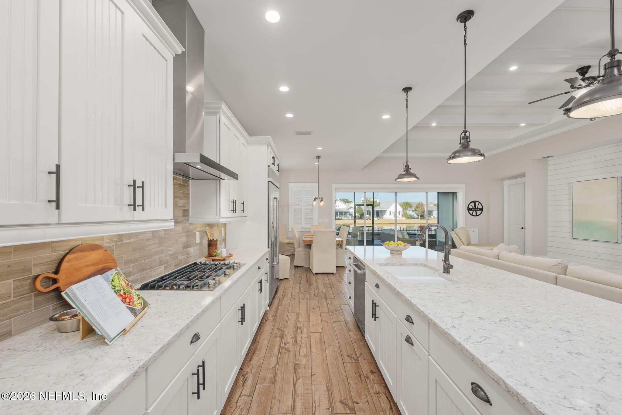 599 Timber Bridge Lane Atlantic Beach, FL 32233 - Photo 30 of 60 a large kitchen with stainless steel appliances granite countertop a lot of counter space and wooden floors