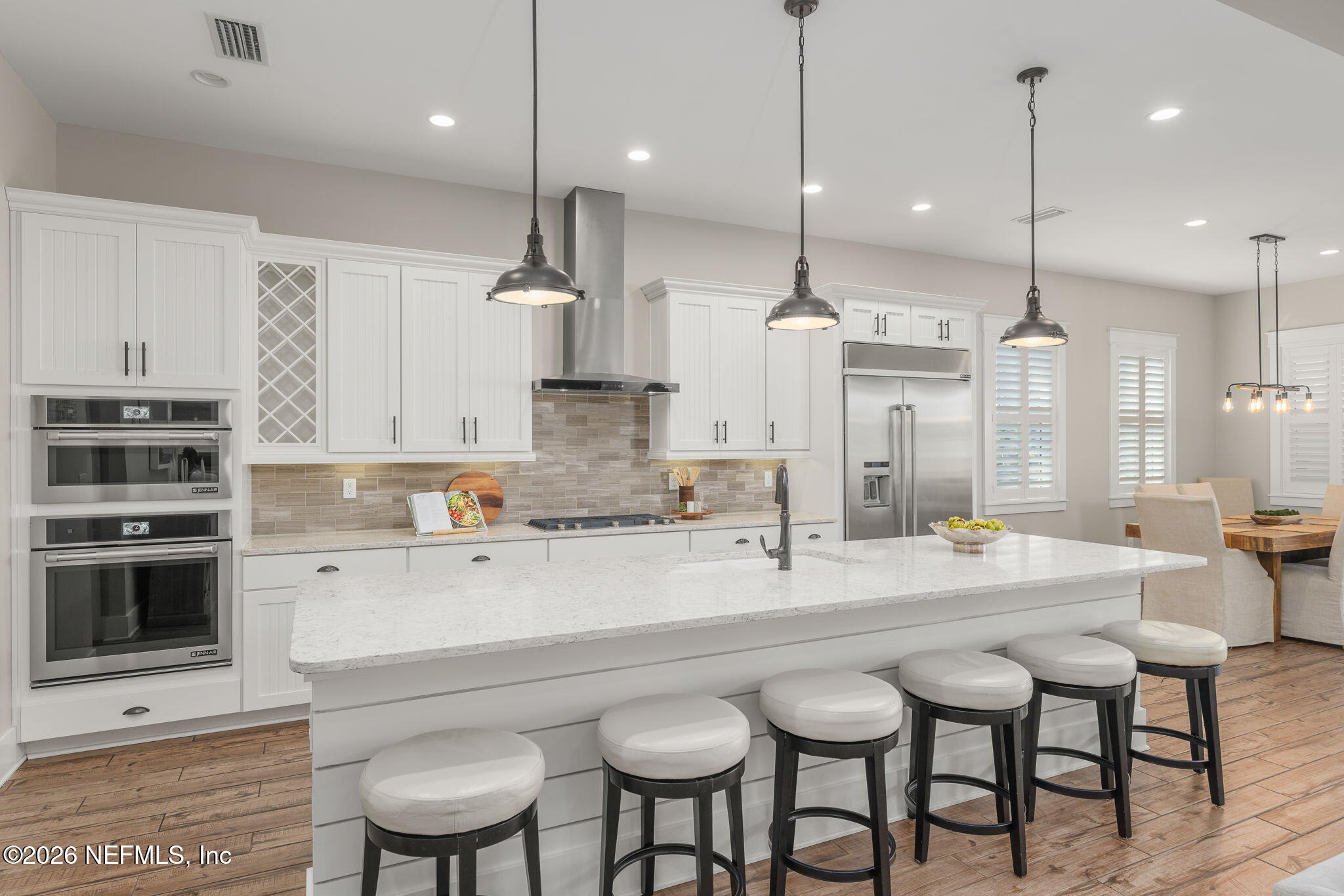 599 Timber Bridge Lane Atlantic Beach, FL 32233 - Photo 31 of 60 a large kitchen with kitchen island a table and chairs in it