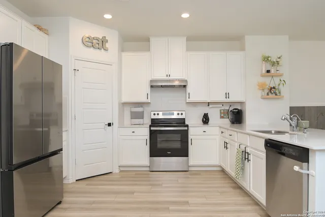 a kitchen with a white stove top oven and refrigerator