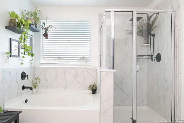 a bathroom with a bathtub and a shower