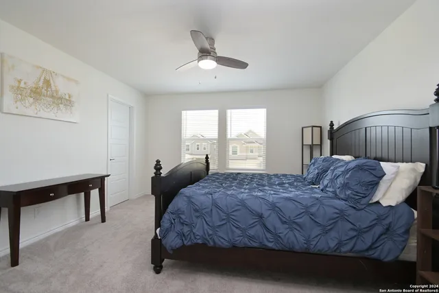 a bedroom with a bed window and a table