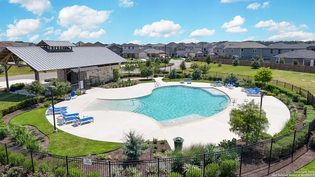 a view of a swimming pool with a table and chairs