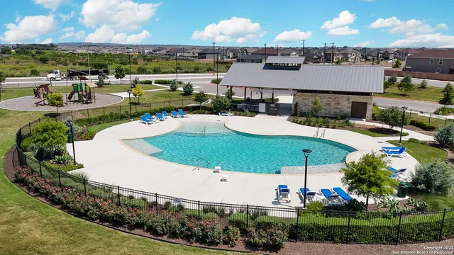 an aerial view of a house with a swimming pool yard and outdoor seating