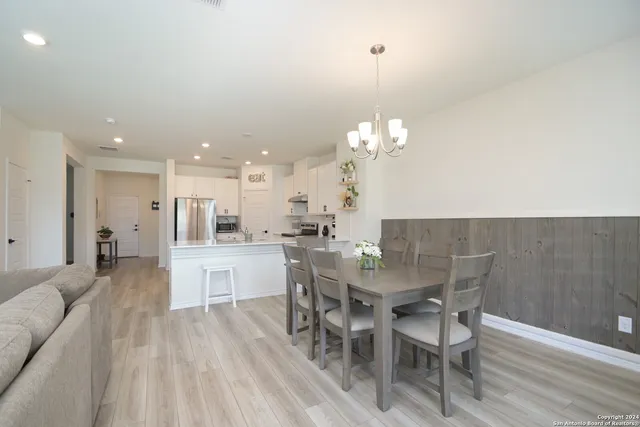 a dining room with furniture and chandelier
