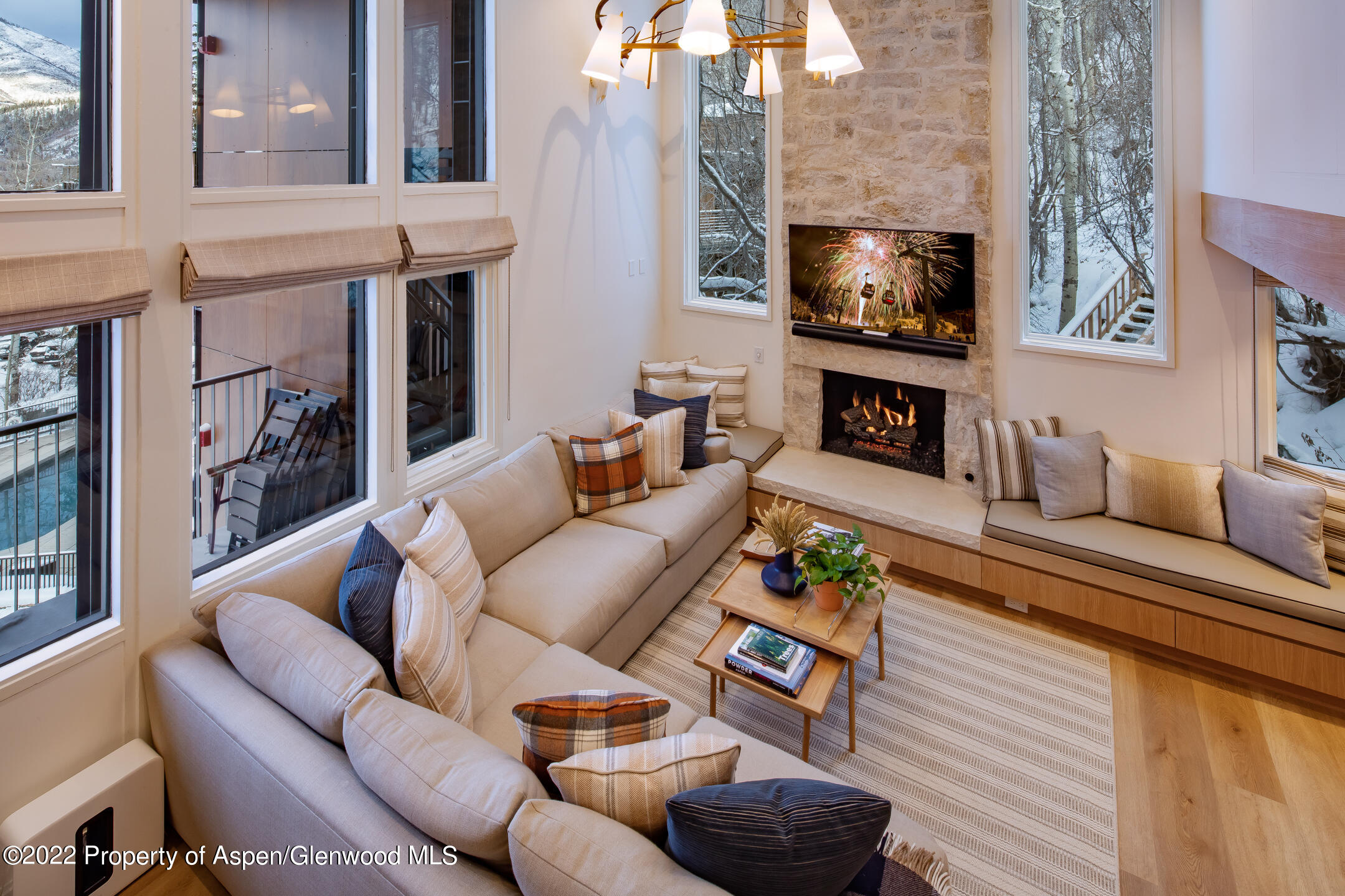 800 South Mill Street, Unit 201C Aspen, CO 81611 - Photo 3 of 13 a living room with furniture a fireplace and a flat screen tv