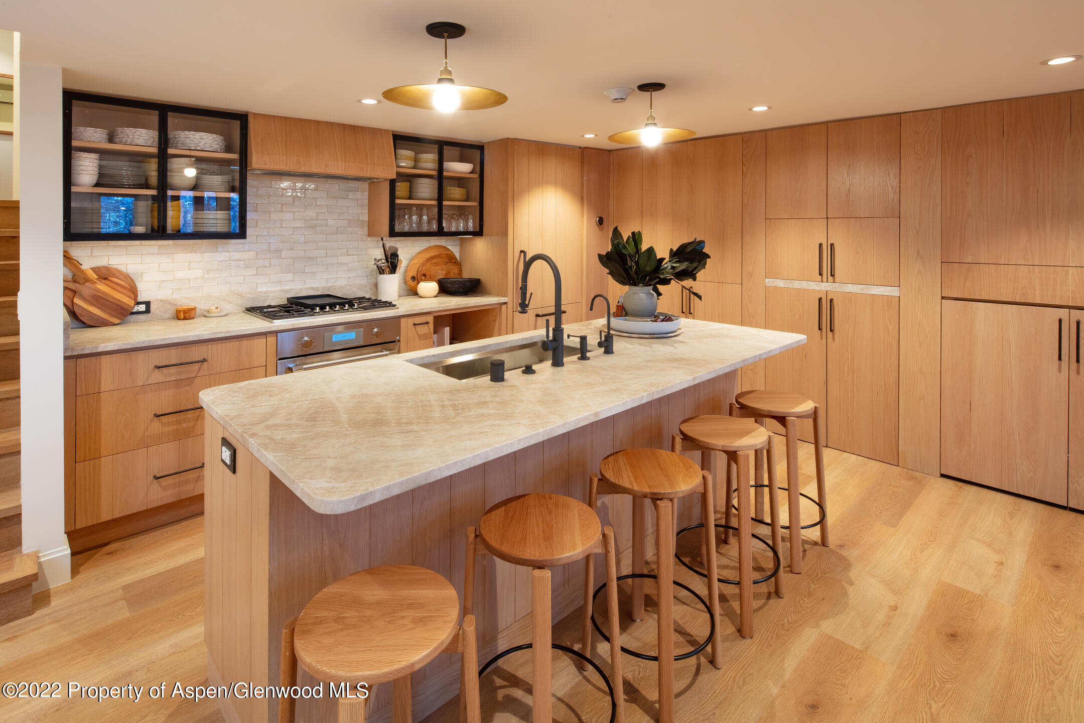 800 South Mill Street, Unit 201C Aspen, CO 81611 - Photo 4 of 13 a kitchen with stainless steel appliances granite countertop a table chairs sink and white cabinets