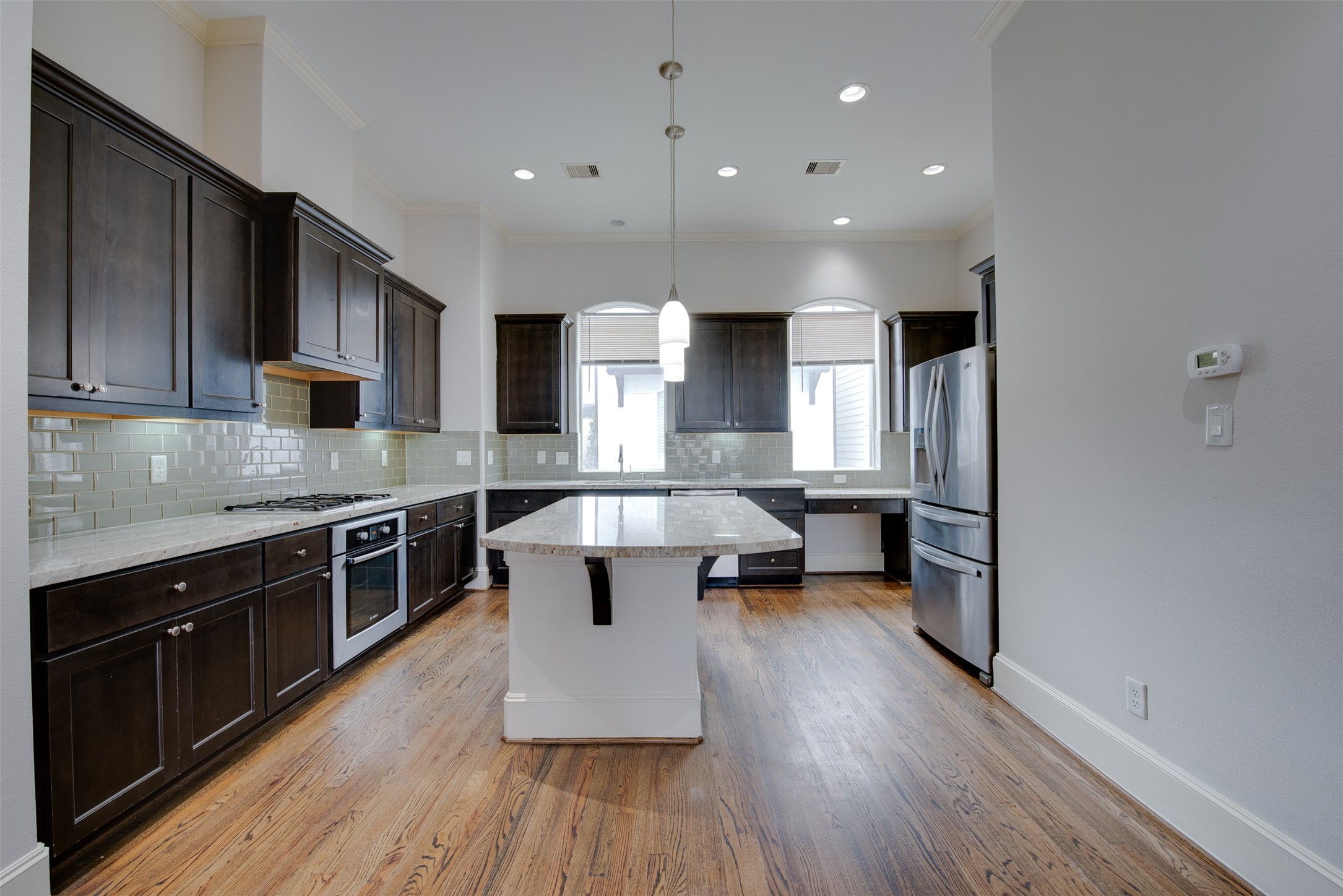 4203 Feagan Street Houston, TX 77007 - Photo 14 of 36 a large kitchen with stainless steel appliances granite countertop a lot of counter space and wooden floor