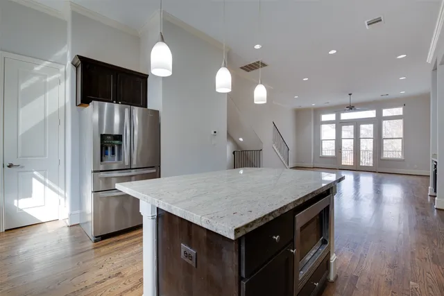 a kitchen with a stove and a wooden floor