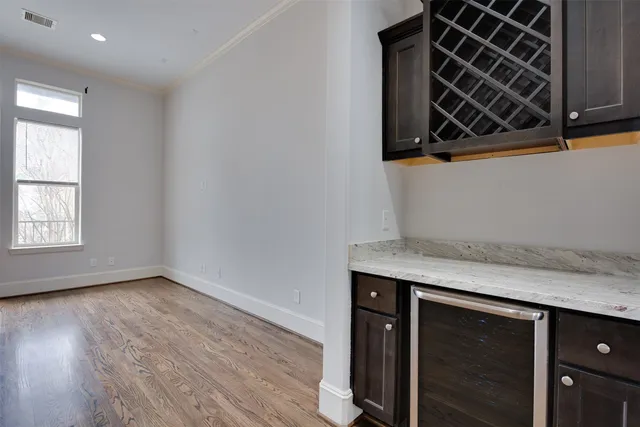 a view of a storage and utility room with wooden floor