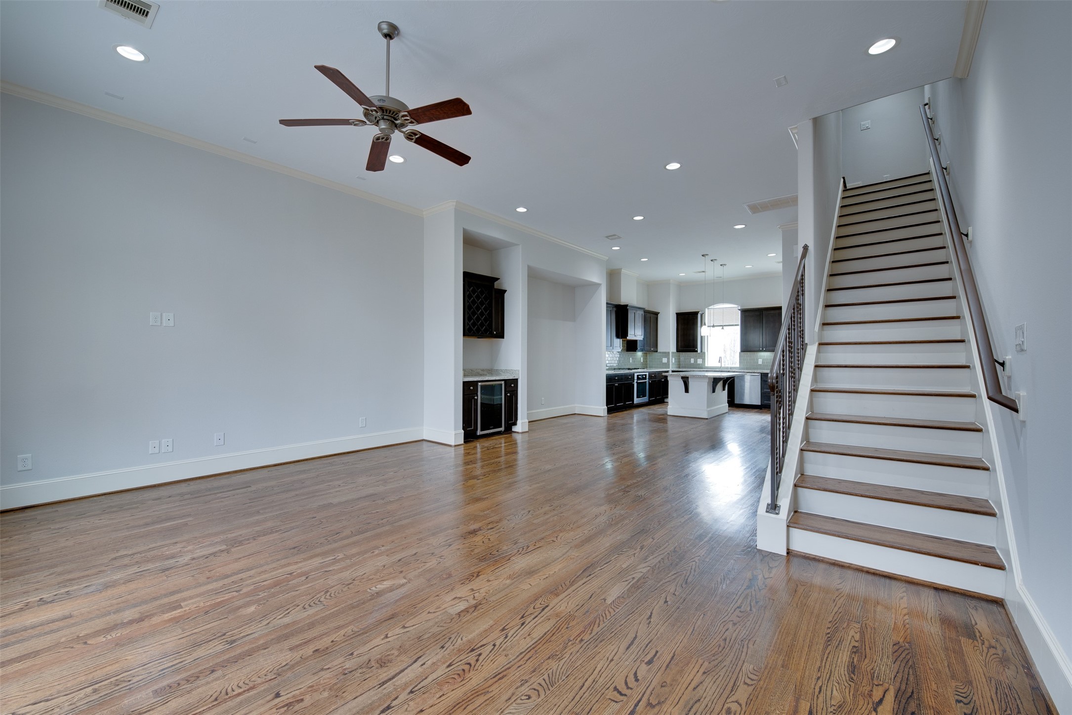4203 Feagan Street Houston, TX 77007 - Photo 25 of 36 a view of a livingroom with wooden floor and a ceiling fan