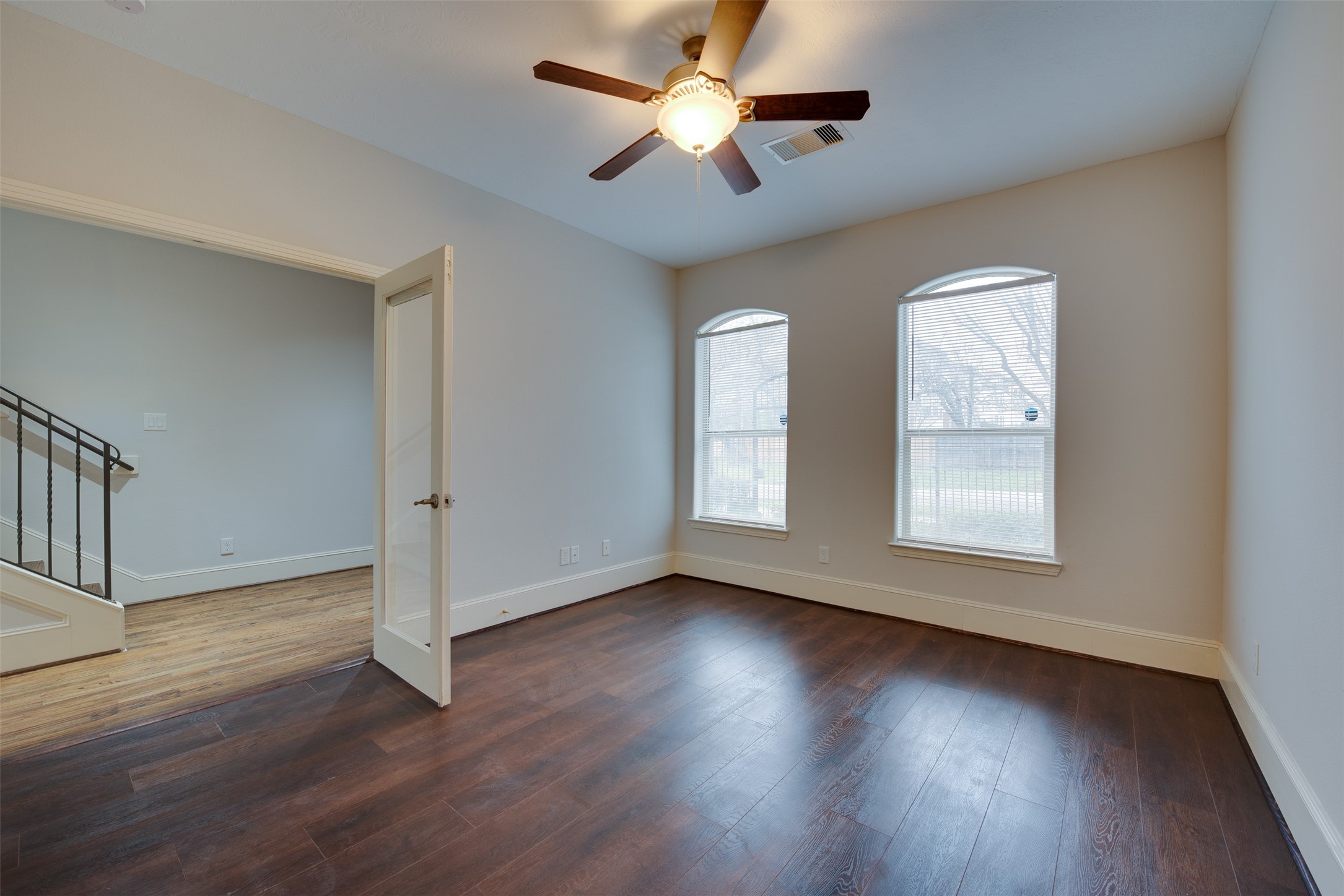 4203 Feagan Street Houston, TX 77007 - Photo 6 of 36 an empty room with wooden floor ceiling fan and windows