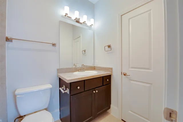a bathroom with a toilet sink and mirror