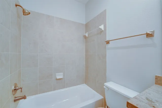 a bathroom with a bathtub and a toilet