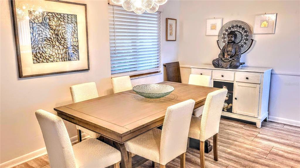 3236 South Lockwood Ridge Road Sarasota, FL 34239 - Photo 14 of 32 a view of a dining room with furniture and wooden floor