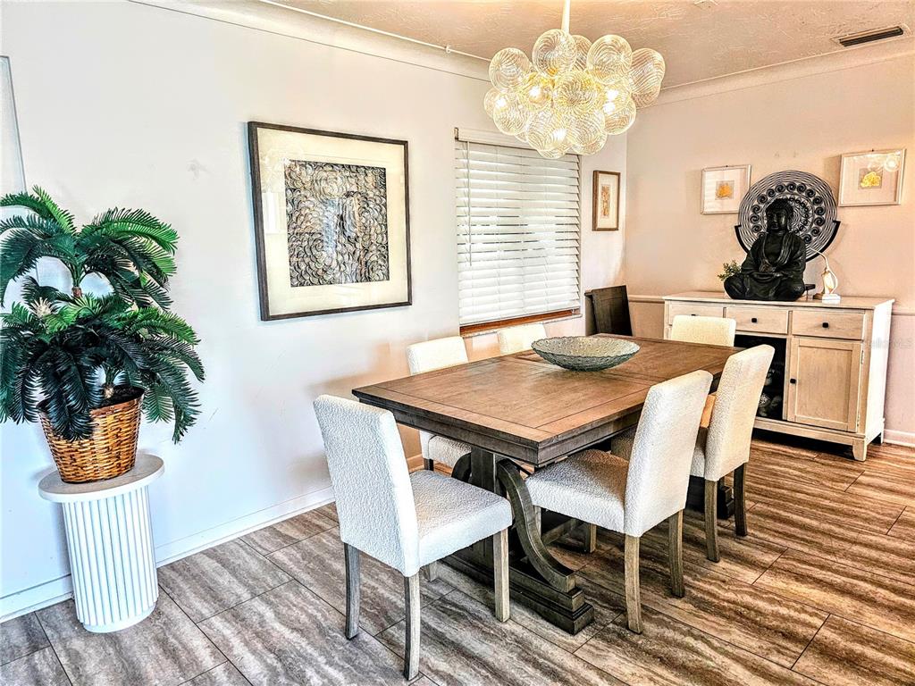 3236 South Lockwood Ridge Road Sarasota, FL 34239 - Photo 20 of 32 a view of a dining room with furniture window and wooden floor