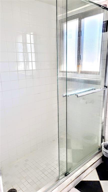 3236 South Lockwood Ridge Road Sarasota, FL 34239 - Photo 28 of 32 a bathroom with a glass shower door