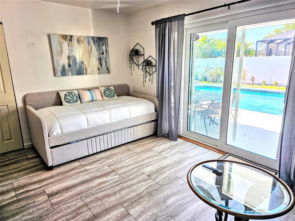 3236 South Lockwood Ridge Road Sarasota, FL 34239 - Photo 30 of 32 a bedroom with a bed and a window