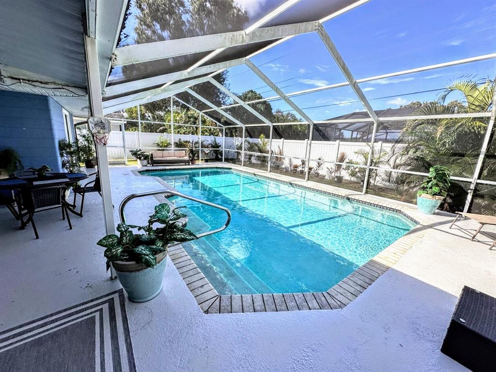 3236 South Lockwood Ridge Road Sarasota, FL 34239 - Photo 31 of 32 a view of a swimming pool with seating area