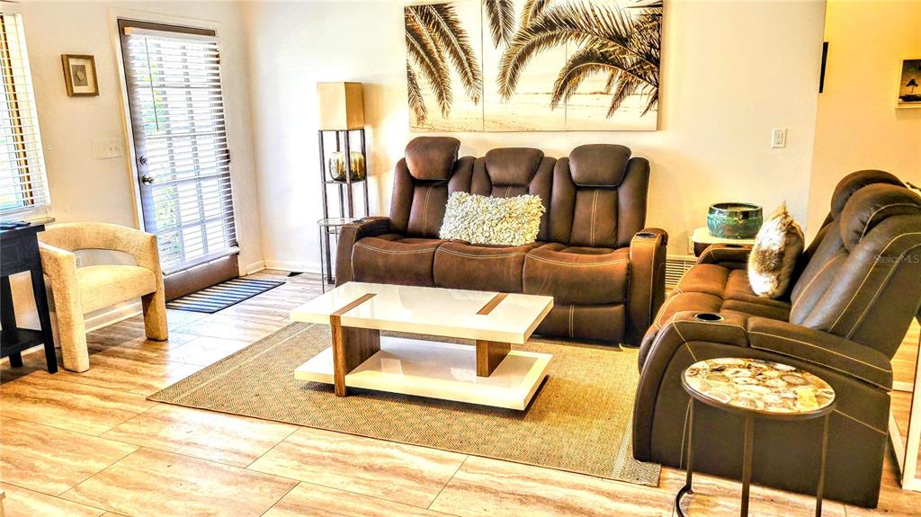 3236 South Lockwood Ridge Road Sarasota, FL 34239 - Photo 4 of 32 a living room with furniture and a window
