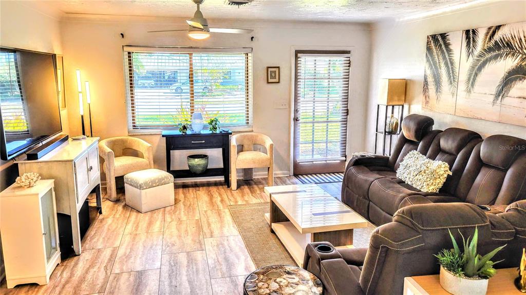 3236 South Lockwood Ridge Road Sarasota, FL 34239 - Photo 5 of 32 a living room with furniture and a large window