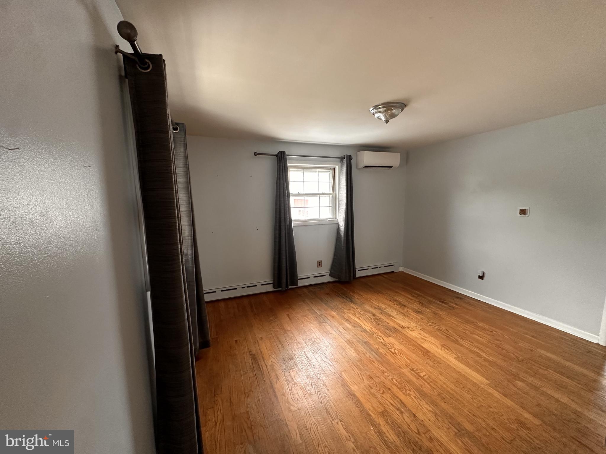 115 Murphy Road Wilmington, DE 19803 - Photo 12 of 17 an empty room with wooden floor and windows