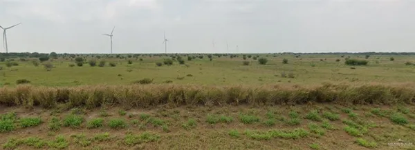a view of a green field with an outdoor space