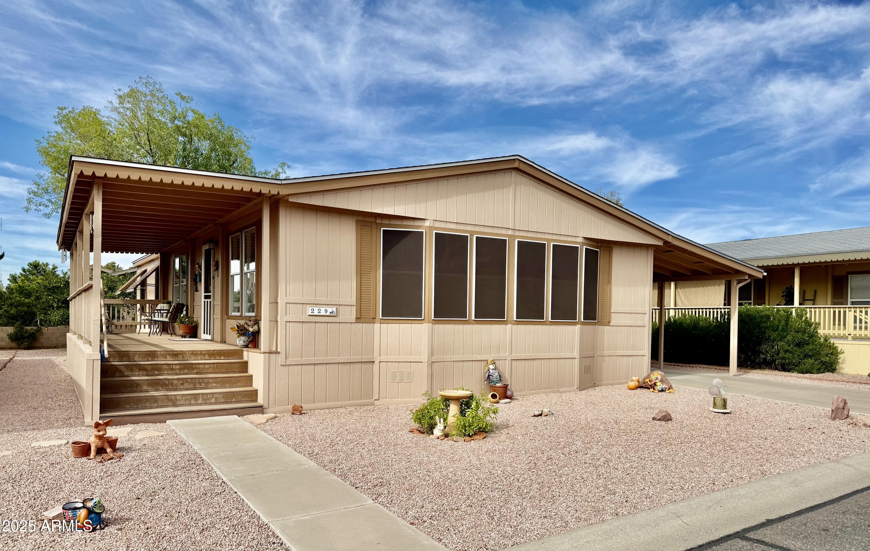 a front view of house with a garden