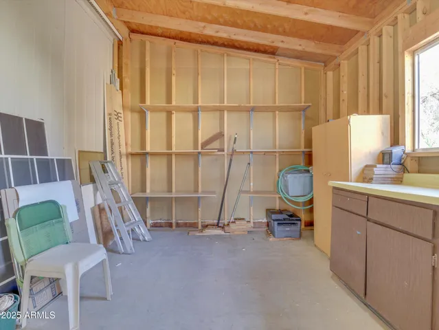 a living room with furniture a rug and white walls