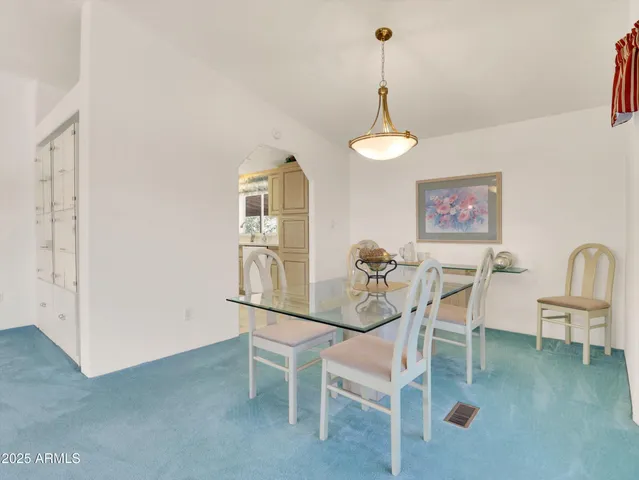 a view of a dining room with furniture and chandelier
