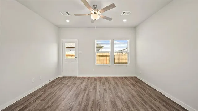 wooden floor in an empty room with a window