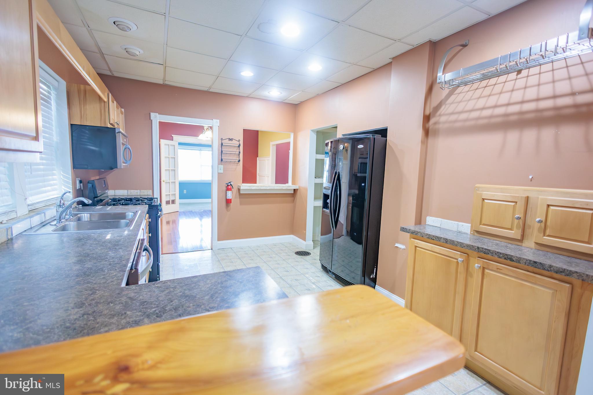 210 Deptford Road Glassboro, NJ 08028 - Photo 12 of 25 a kitchen with stainless steel appliances kitchen island granite countertop a refrigerator and a stove