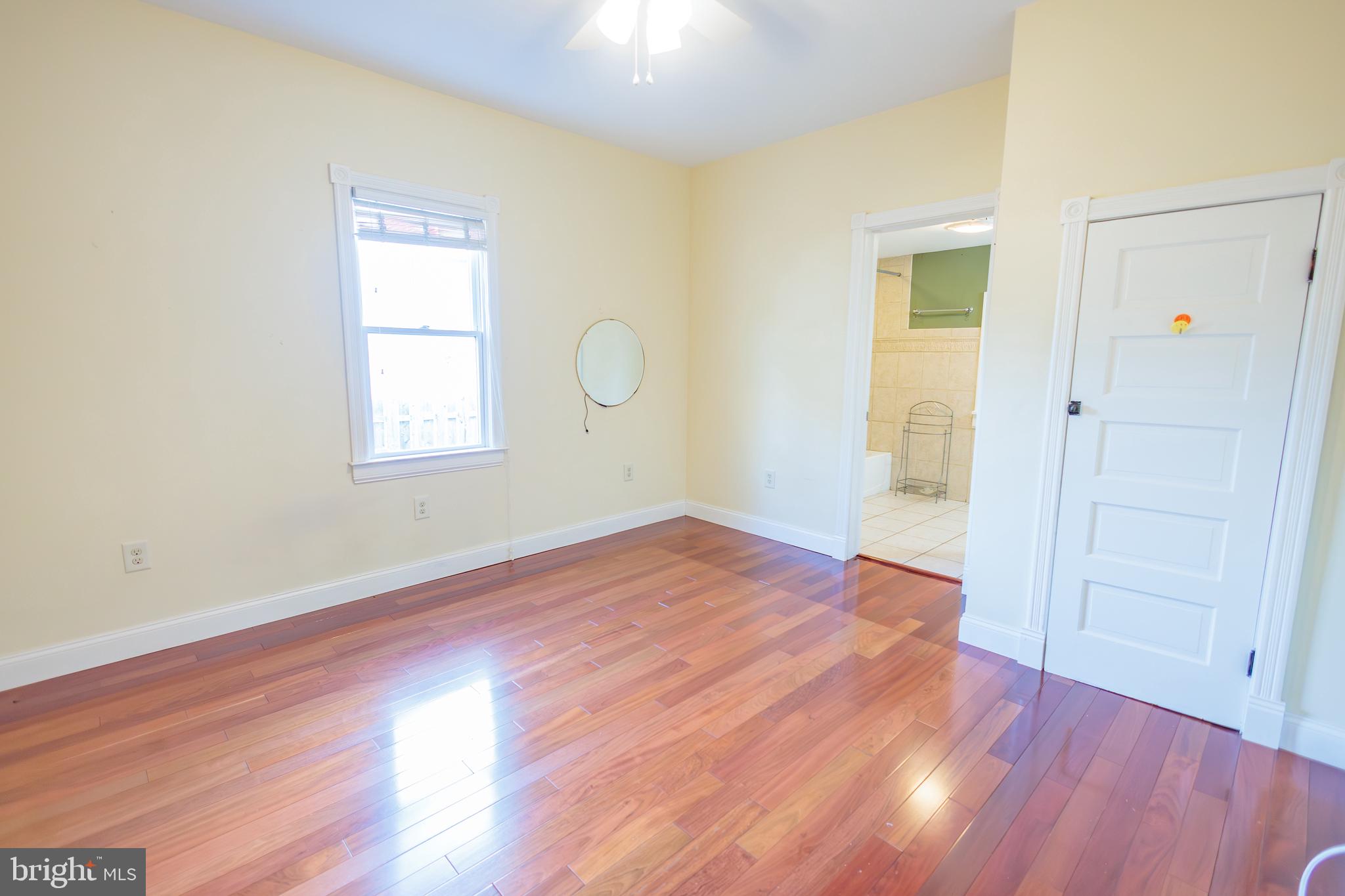 210 Deptford Road Glassboro, NJ 08028 - Photo 15 of 25 an empty room with wooden floor and windows