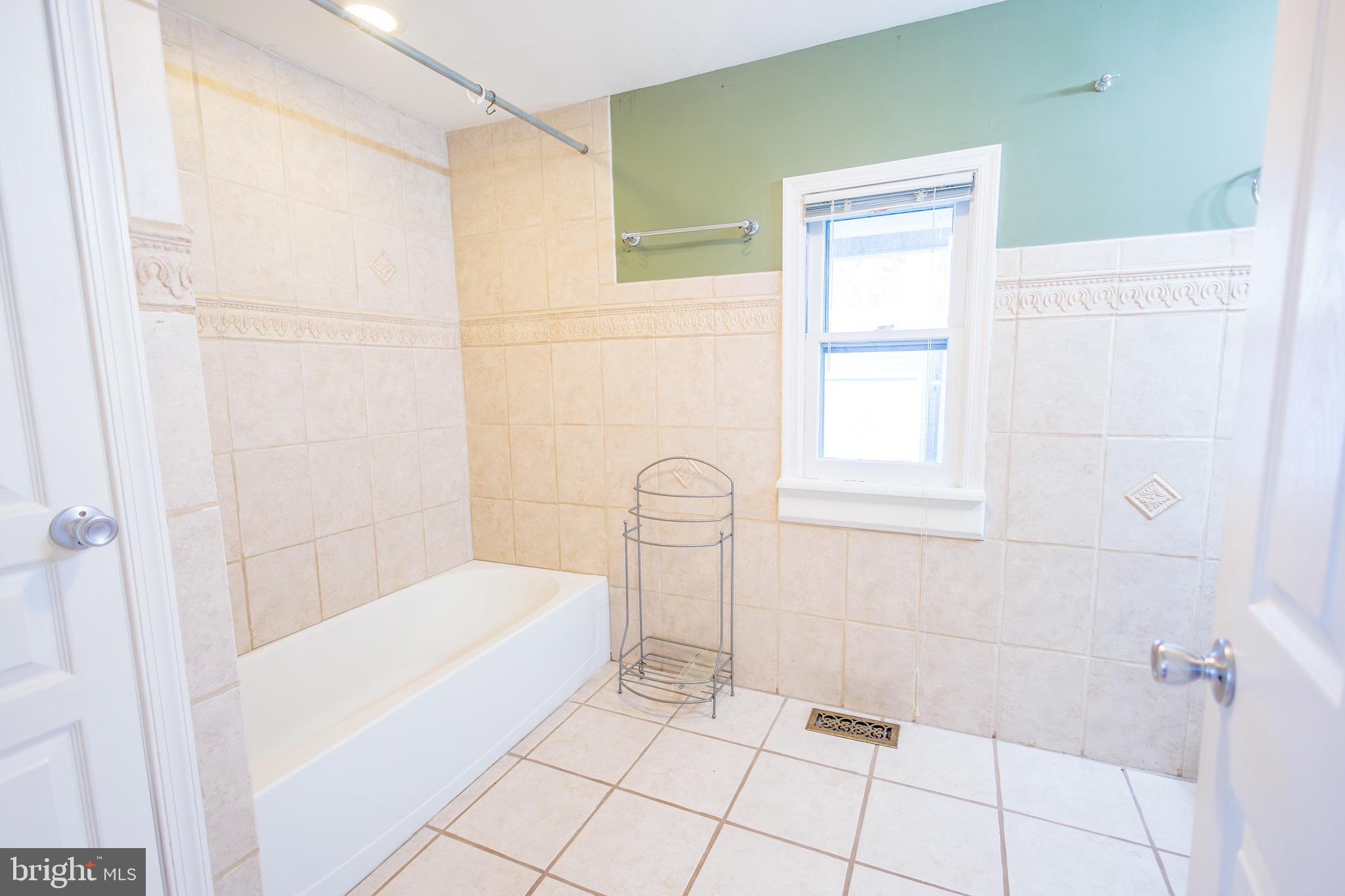 210 Deptford Road Glassboro, NJ 08028 - Photo 17 of 25 a bathroom with a bathtub and shower