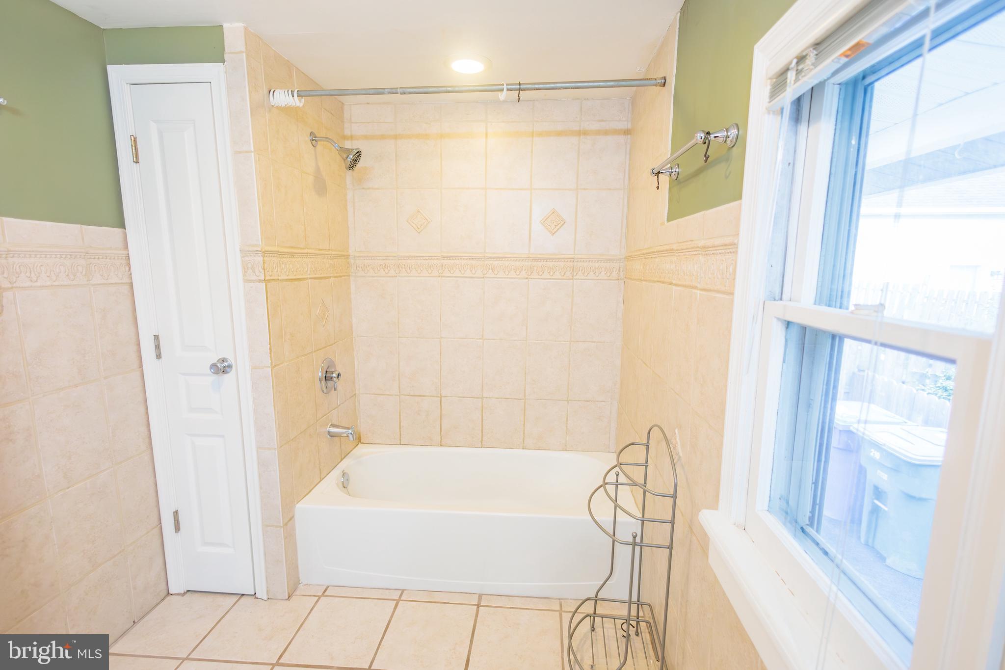 210 Deptford Road Glassboro, NJ 08028 - Photo 18 of 25 a bathroom with a bathtub and a shower