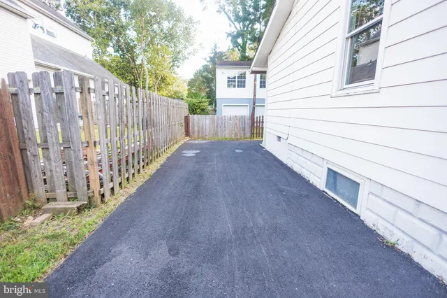 a view of a house with wooden fence
