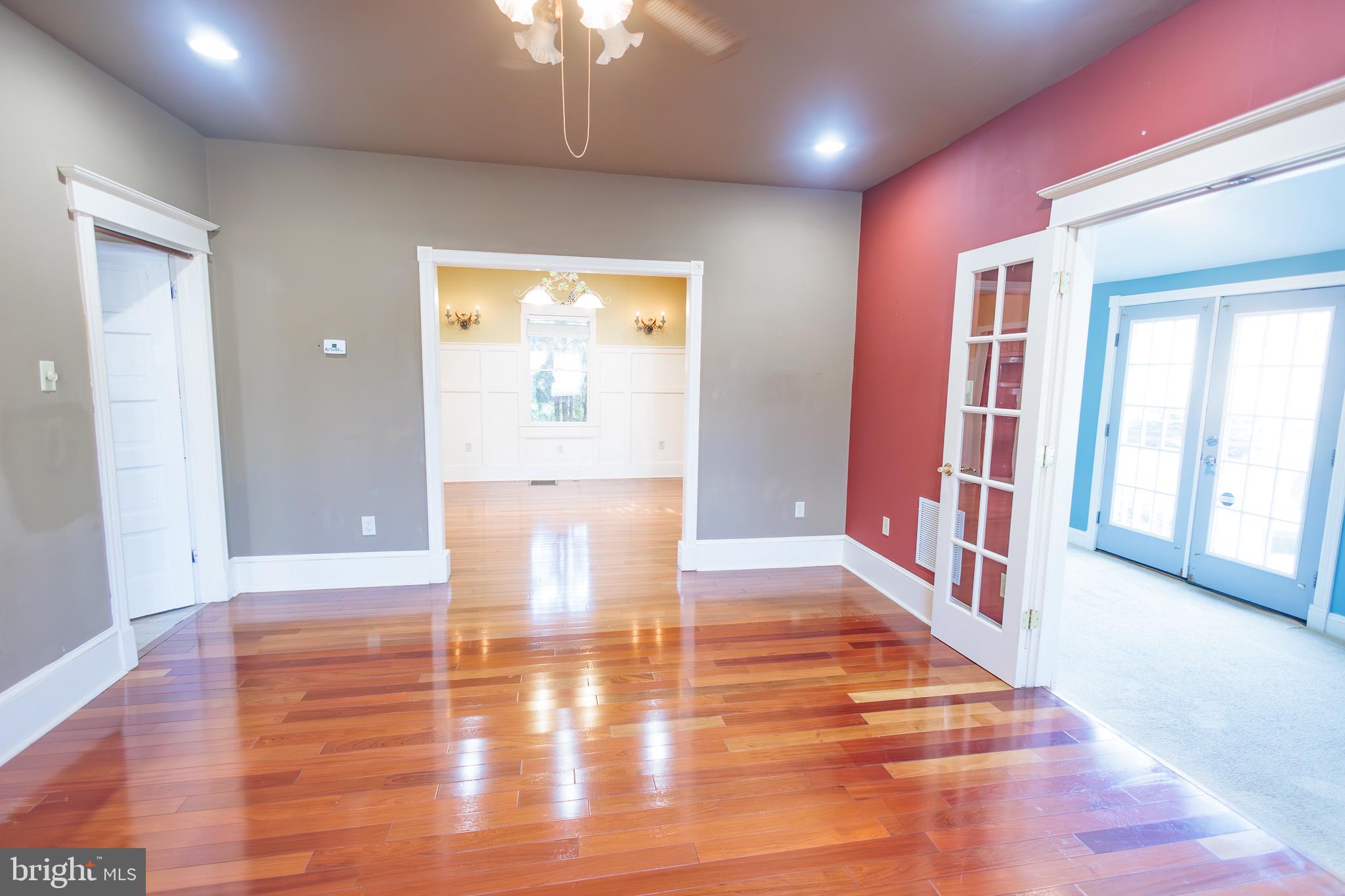 210 Deptford Road Glassboro, NJ 08028 - Photo 8 of 25 a view of an empty room with wooden floor and a window