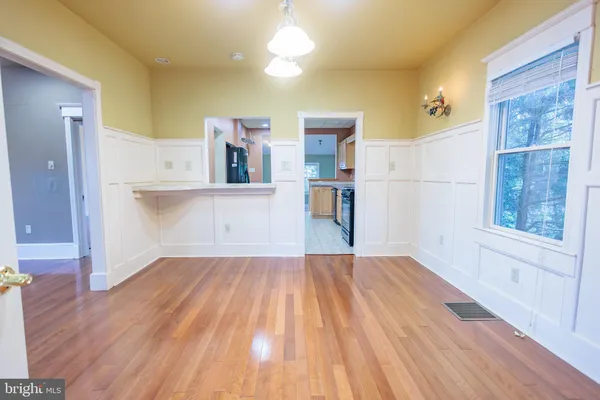 a view of a room with wooden floor and staircase