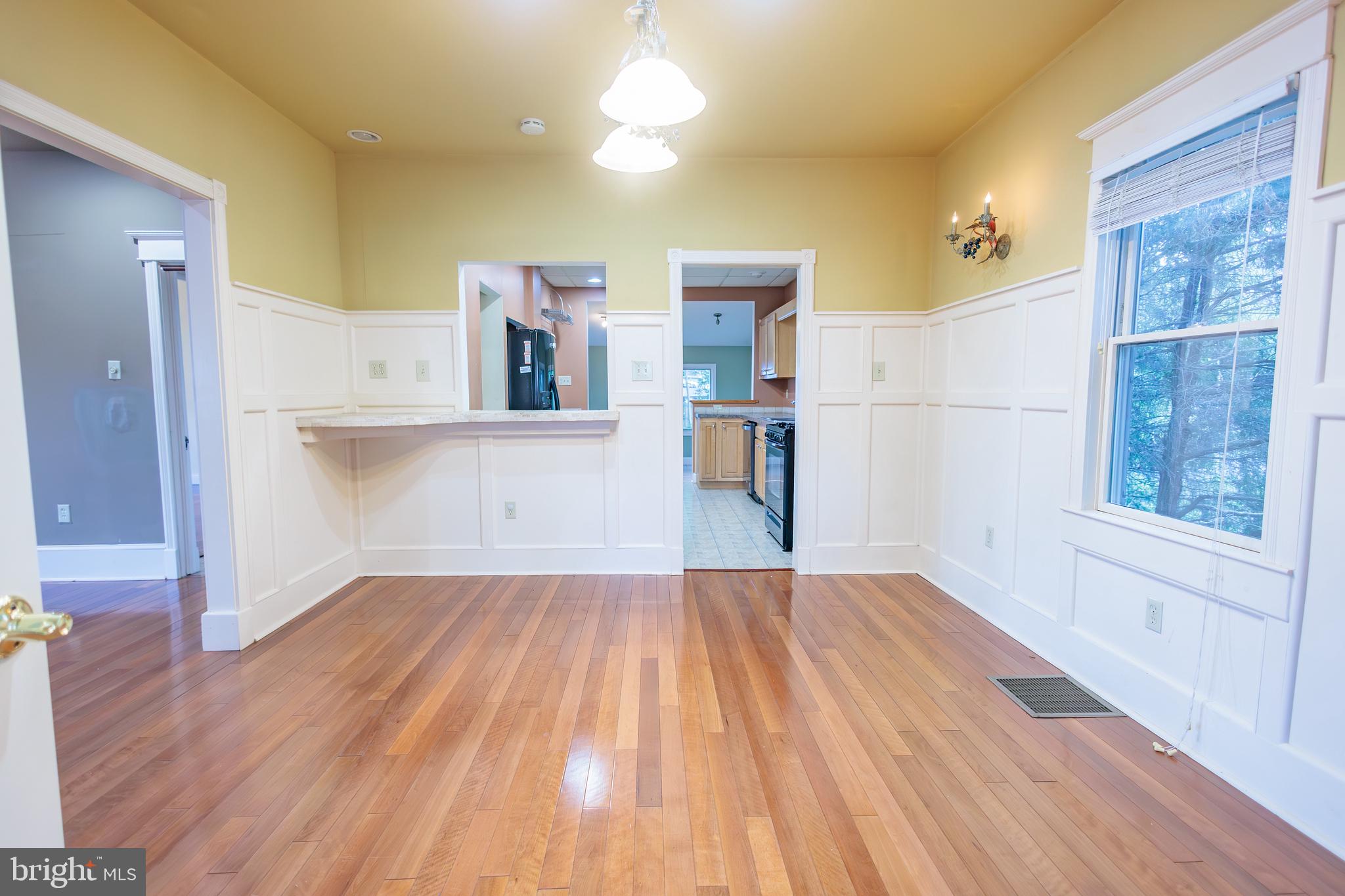 210 Deptford Road Glassboro, NJ 08028 - Photo 9 of 25 a view of a kitchen with wooden floor and a kitchen