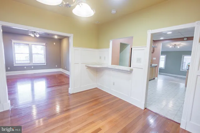 a kitchen with stainless steel appliances granite countertop a stove top oven a sink dishwasher and white cabinets