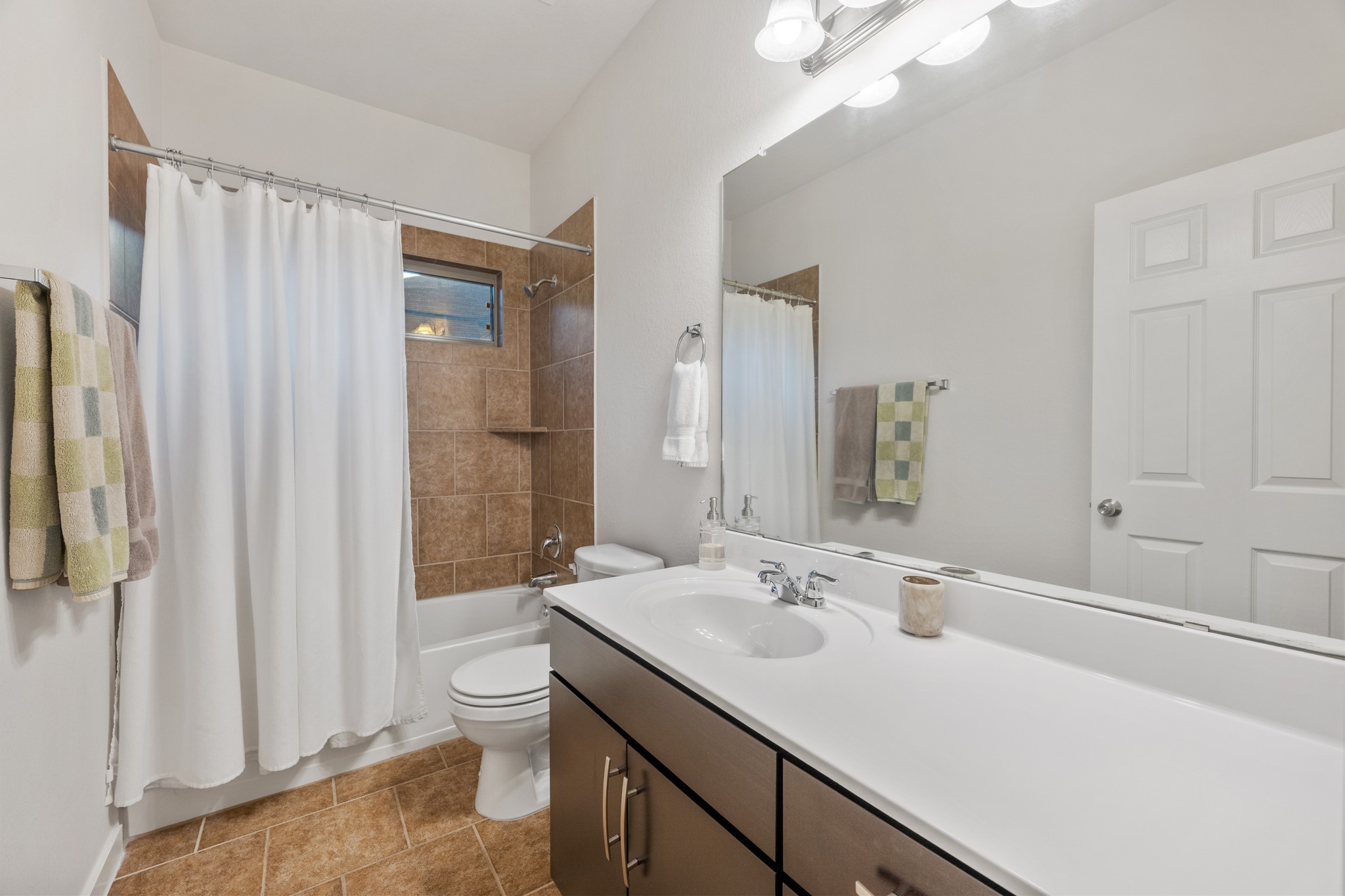 2101 Rivers Edge Way, Unit 19 Austin, TX 78741 - Photo 17 of 24 a bathroom with a sink a toilet and shower