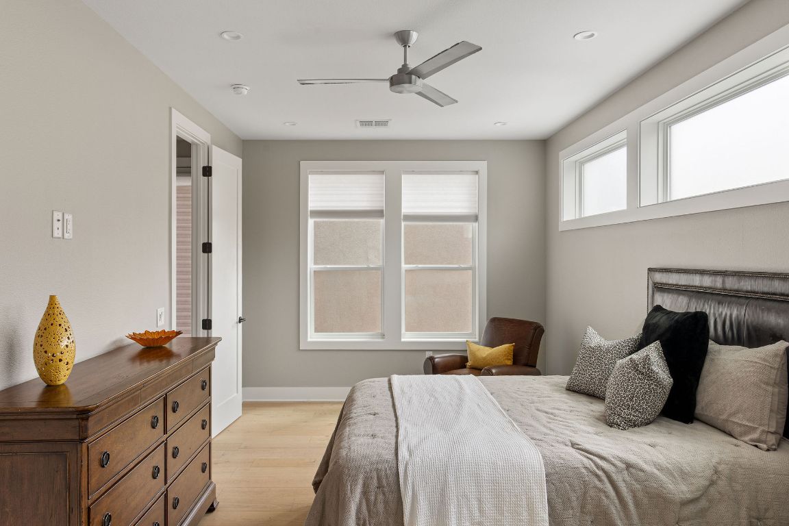 13410 Galleria Circle Austin, TX 78738 - Photo 11 of 28 a bedroom with a bed and wooden floor