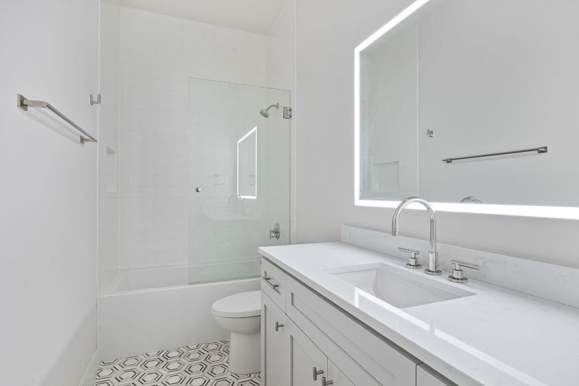 13410 Galleria Circle Austin, TX 78738 - Photo 16 of 28 a bathroom with a sink toilet vanity and shower