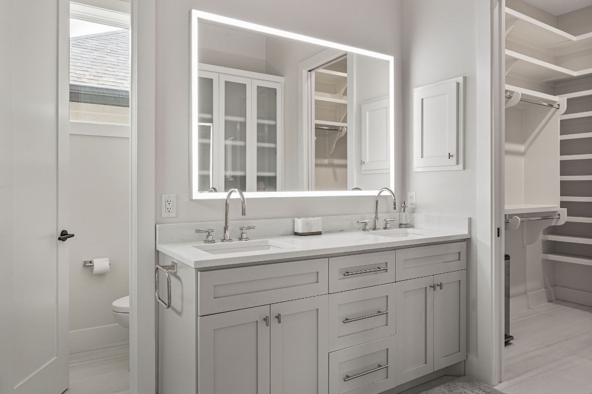 13410 Galleria Circle Austin, TX 78738 - Photo 23 of 28 a bathroom with a granite countertop sink and a mirror
