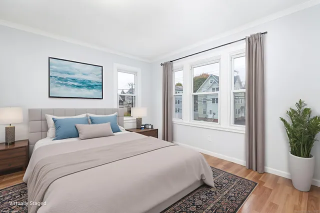 a bedroom with a large bed and a window