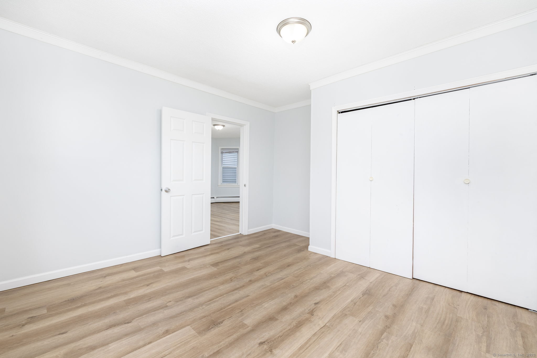 80 Belden Street, Unit 2 New Britain, CT 06051 - Photo 3 of 15 a view of an empty room with wooden floor