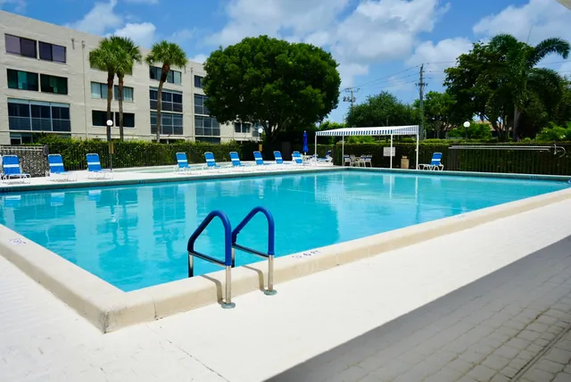 a room with pool table and windows