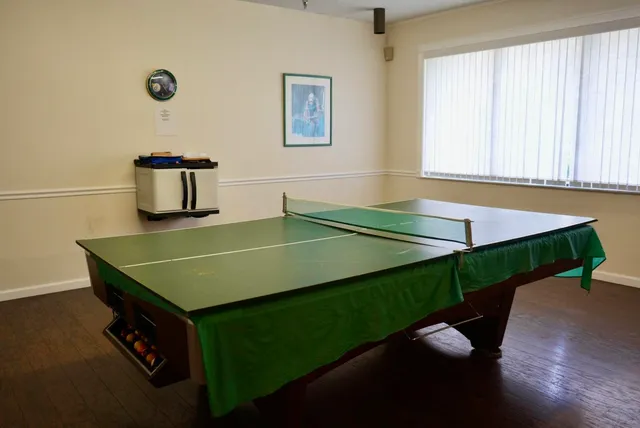 a view of a a dining room with furniture window and wooden floor