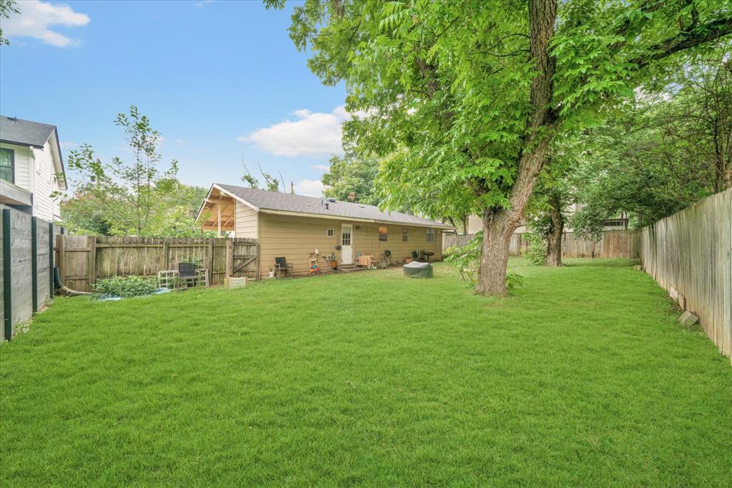 1104 Kinney Avenue, Unit B Austin, TX 78704 - Photo 12 of 14 a view of a house with a big yard and large trees