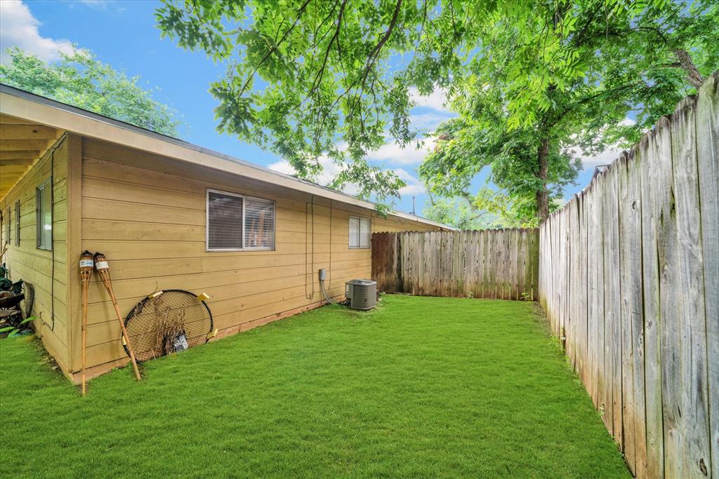 1104 Kinney Avenue, Unit B Austin, TX 78704 - Photo 14 of 14 a view of a backyard with potted plants and a large tree