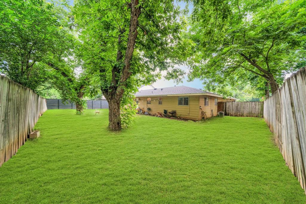 1104 Kinney Avenue, Unit B Austin, TX 78704 - Photo 4 of 14 a yellow house in middle of the forest